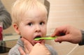 Dad and son brush their teeth in the bathroom. Father Brushing Teeth to Child