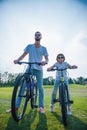 Dad and son cycling Royalty Free Stock Photo