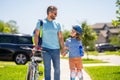 dad and son duo pedaling through picturesque landscape. Biking camaraderie. supportive dad guiding his son first bike Royalty Free Stock Photo