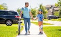 dad and son duo pedaling through picturesque landscape. supportive dad guiding his son first bike ride. dad and son Royalty Free Stock Photo