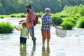 Dad and son fishing at lake. Grandfather, father and grandson fishing together. Grandson with father and grandfather Royalty Free Stock Photo