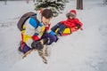 Dad and son have fun on tubing in the winter. Winter fun for the whole family Royalty Free Stock Photo