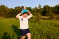 Dad and son having fun in nature in summer, father holding his child on his shoulders with pinwheel