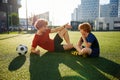 Dad and son having nice conversation after football training recreation activity Royalty Free Stock Photo