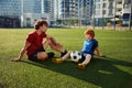 Dad and son having nice conversation after football training recreation activity Royalty Free Stock Photo