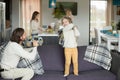 Dad and son having pillow fight playing together on sofa Royalty Free Stock Photo