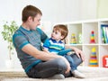 Dad and son kid play with tablet computer indoors Royalty Free Stock Photo