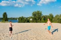 Dad and son play beach soccer on the beach on a sunny warm day. Concept about sports and active games in summer. Healthy lifestyle Royalty Free Stock Photo
