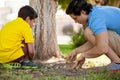 Dad and son playing with marbles Royalty Free Stock Photo