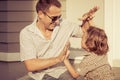 Dad and son playing near a house Royalty Free Stock Photo