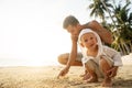 Dad and son playing on the sand at the beach at sunset Royalty Free Stock Photo