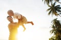 Dad and son playing on the sand at the beach at sunset Royalty Free Stock Photo