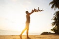 Dad and son playing on the sand at the beach at sunset Royalty Free Stock Photo