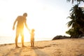 Dad and son playing on the sand at the beach at sunset Royalty Free Stock Photo