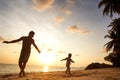 Dad and son playing on the sand at the beach at sunset Royalty Free Stock Photo