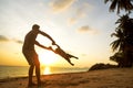 Dad and son playing on the sand at the beach at sunset Royalty Free Stock Photo