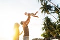 Dad and son playing on the sand at the beach at sunset Royalty Free Stock Photo