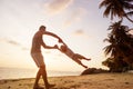 Dad and son playing on the sand at the beach at sunset Royalty Free Stock Photo