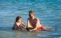 dad and son playing together. happy moments with father and son. Father son beach adventure playing with toy ship