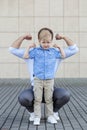 Dad and son are a preschooler playing. Show muscles. The concept of childhood, parenting and fatherhood