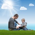 Dad and son reading a book on nature