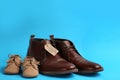 Dad and son`s shoes on blue background. Happy Father`s Day Royalty Free Stock Photo