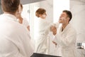 Dad and son with shaving foam on their faces having fun Royalty Free Stock Photo