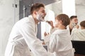 Dad and son with shaving foam on their faces having fun Royalty Free Stock Photo