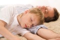 Dad and son sleeping on the carpet Royalty Free Stock Photo