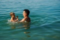 Dad and son splashing in the water merrily. Summer family vacations Royalty Free Stock Photo