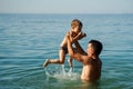 Dad and son splashing in the water merrily. Summer family vacations Royalty Free Stock Photo