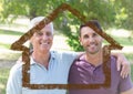 Dad and son standing together in the park with house outline Royalty Free Stock Photo
