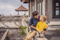Dad and son tourists in abandoned and mysterious hotel in Bedugul. Indonesia, Bali Island. Bali Travel Concept