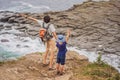 Dad and son tourists on the background of beautiful rocks and the sea. Hiking concept. Tobizin cape. Vladivostok, island Royalty Free Stock Photo