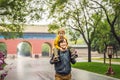 Dad and son are tourists on the background of the large Chinese gates. Travel with children in China concept