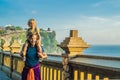 Dad and son travelers in Pura Luhur Uluwatu temple, Bali, Indonesia. Amazing landscape - cliff with blue sky and sea. Traveling w Royalty Free Stock Photo