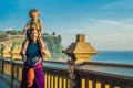 Dad and son travelers in Pura Luhur Uluwatu temple, Bali, Indonesia. Amazing landscape - cliff with blue sky and sea. Traveling w Royalty Free Stock Photo