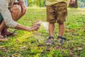 Dad and son use mosquito spray.Spraying insect repellent on skin outdoor Royalty Free Stock Photo