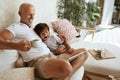 Dad And Son Using Tablet On Family Weekend At Villa. Happy Father With Little Boy Sitting On Sofa. Royalty Free Stock Photo