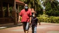 Dad and son wearing face mask walking together. Coronavirus pandemic.Family, lifestyle, fashion and quarantine. Father with child