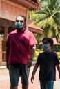 Dad and son wearing face mask walking together. Coronavirus pandemic.Family, lifestyle, fashion and quarantine. Father with child