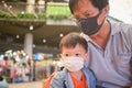 Dad and son wearing protective medical mask in public area, Concept of coronavirus quarantines and Air pollution pm2.5 in Thailand