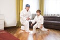 Dad and son in white kimono judo training at home.