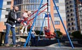 Dad swinging cute daughter on swing at playground in autumn. Royalty Free Stock Photo