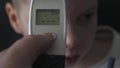 Dad Taking Sons Temperature Using a Digital Thermometer Covid 19 Virus Symptom - Epidemic Coronavirus Outbreak Conceptconcept.