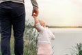 Dad teaches daughter to walk in nature. Father and daughter. First steps. Royalty Free Stock Photo