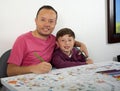 Dad teaches his son how to paint Royalty Free Stock Photo