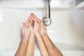 Dad teaches little daughter thorough washing hands