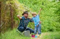 Dad teaching little son care plants. Personal example. Spring garden. Little helper in garden. Planting flowers. Growing Royalty Free Stock Photo