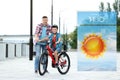 Dad teaching son to ride bicycle and weather forecast widget. Mobile application